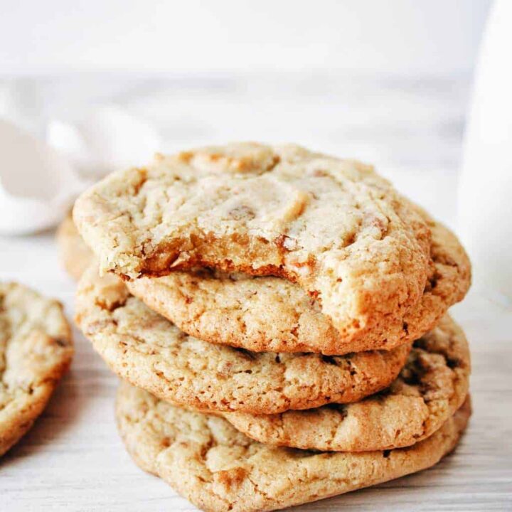 stack of heath bar cookies with one bite