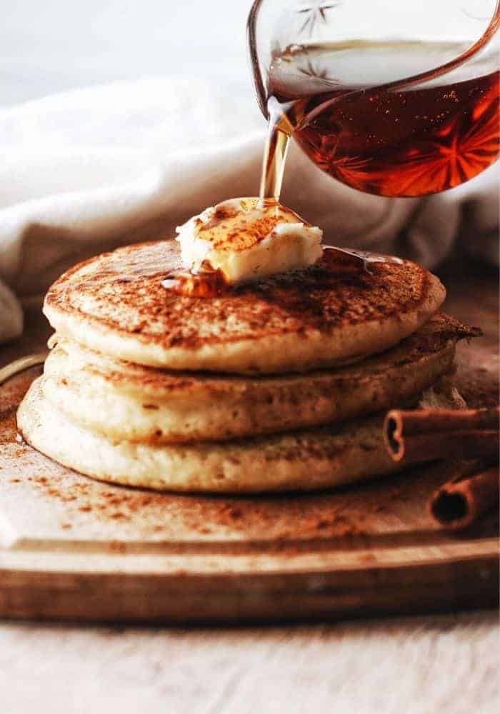 stack of fluffy buttermilk pancakes with butter and syrup