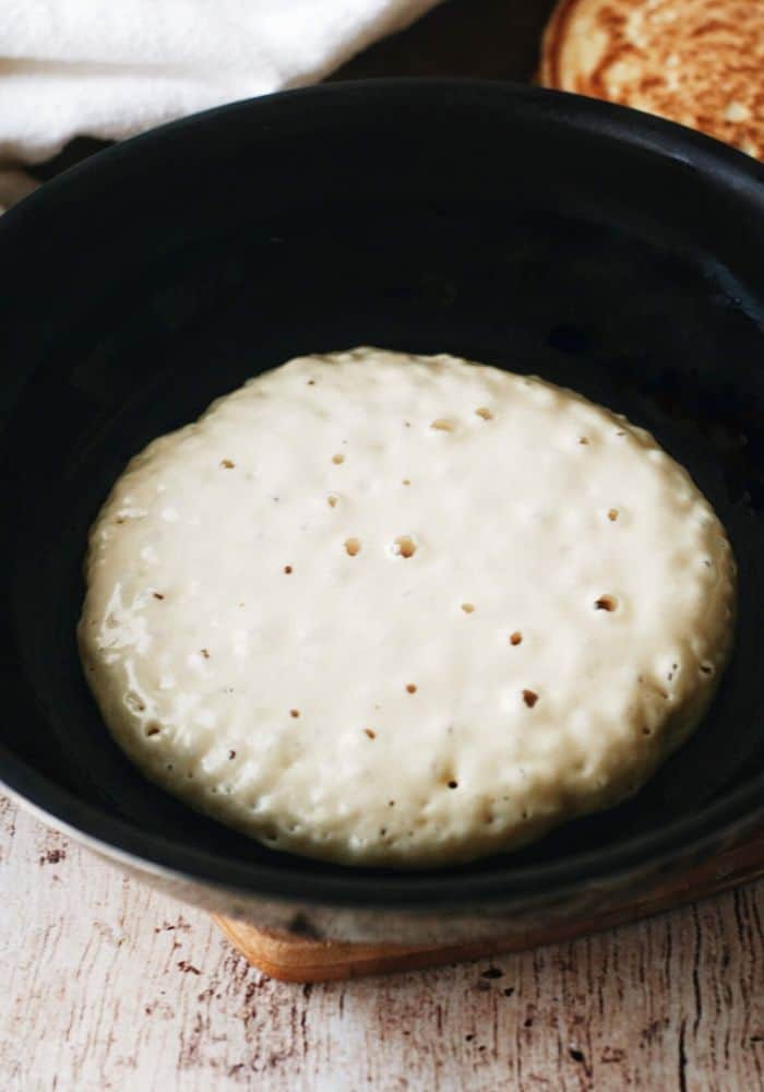 pancake in a pan with bubbles ready to flip