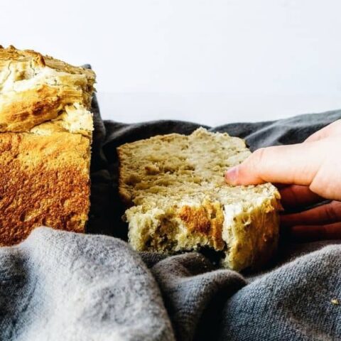 hand reaching for a slice of bread