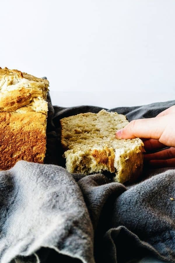 hand reaching for a slice of bread