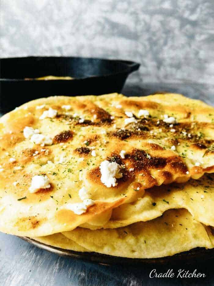 stacked buttermilk naan bread with onion salt and feta cheese