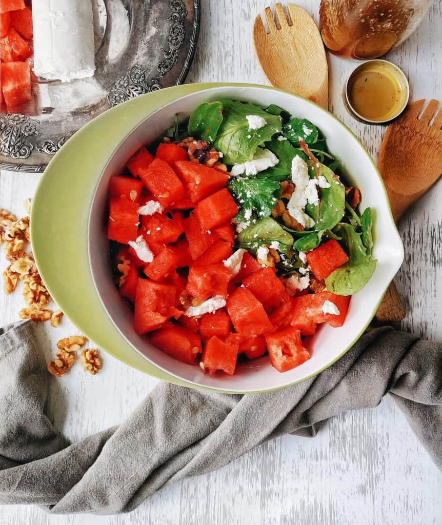 watermelon goat cheese and walnuts in a salad bowl