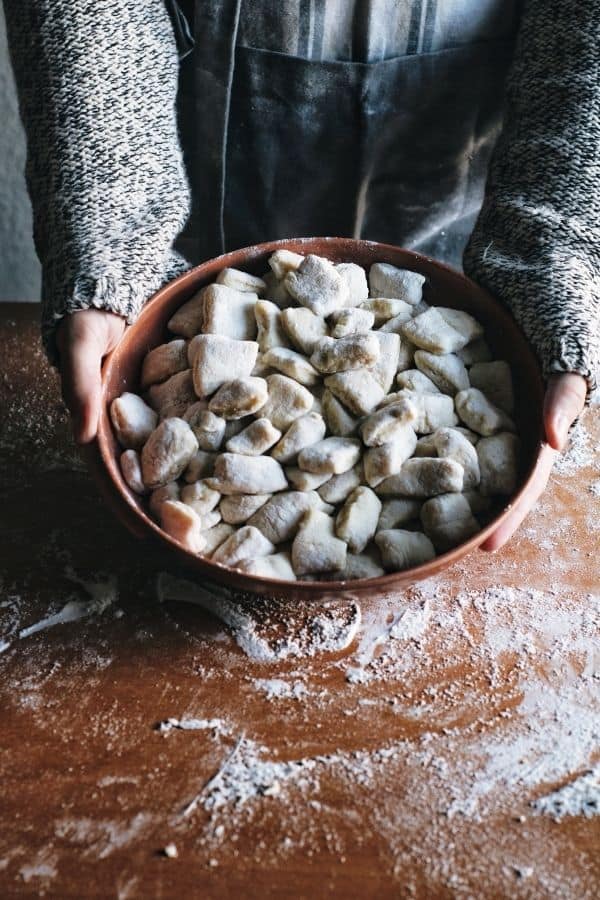 hands holding a bowl of fresh made gnocchi