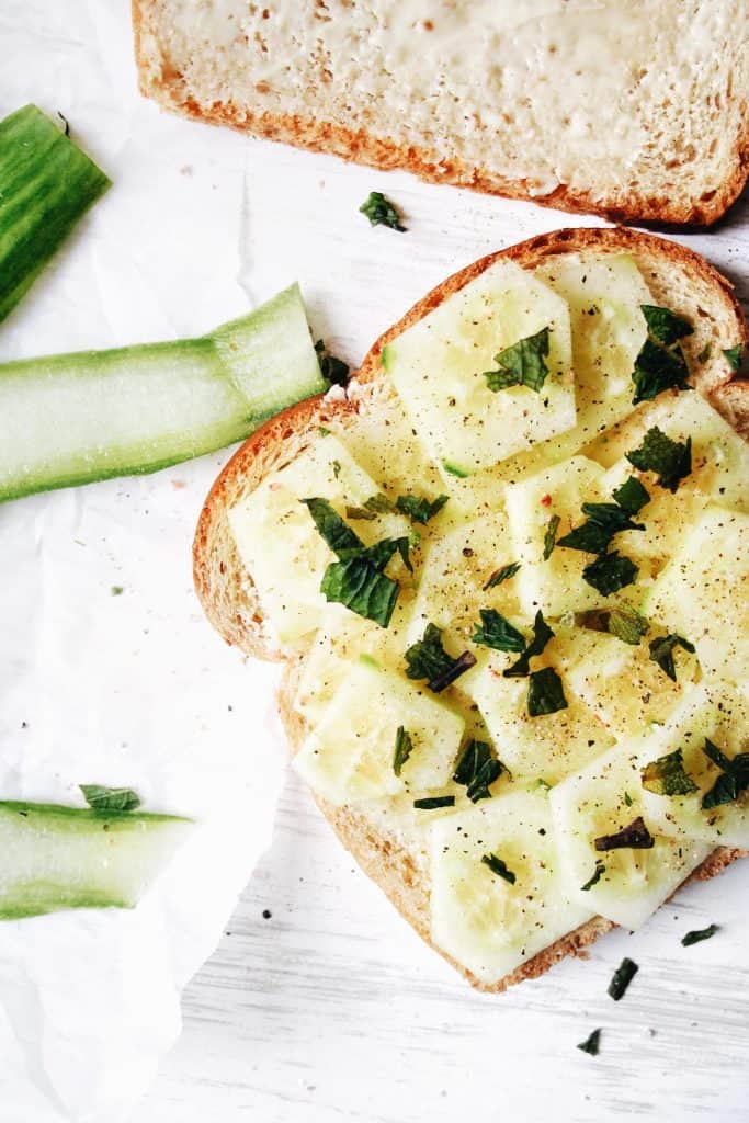 bread with butter and cucumbers and seasonings