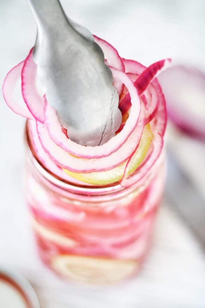close up of pickled red onions out of the jar
