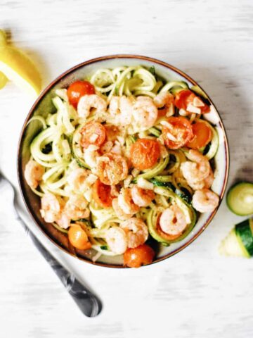 bowl of zucchini noodles with shrimp and tomatoes