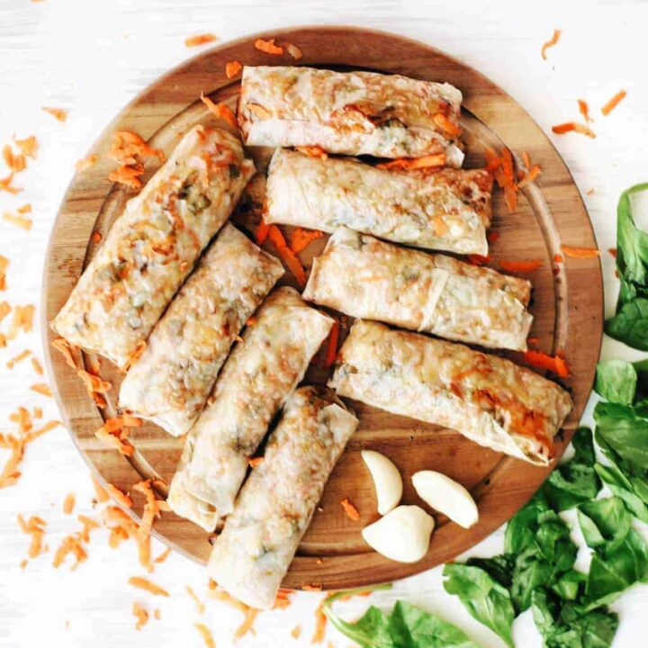 platter of baked spring rolls with spinach and shredded carrots