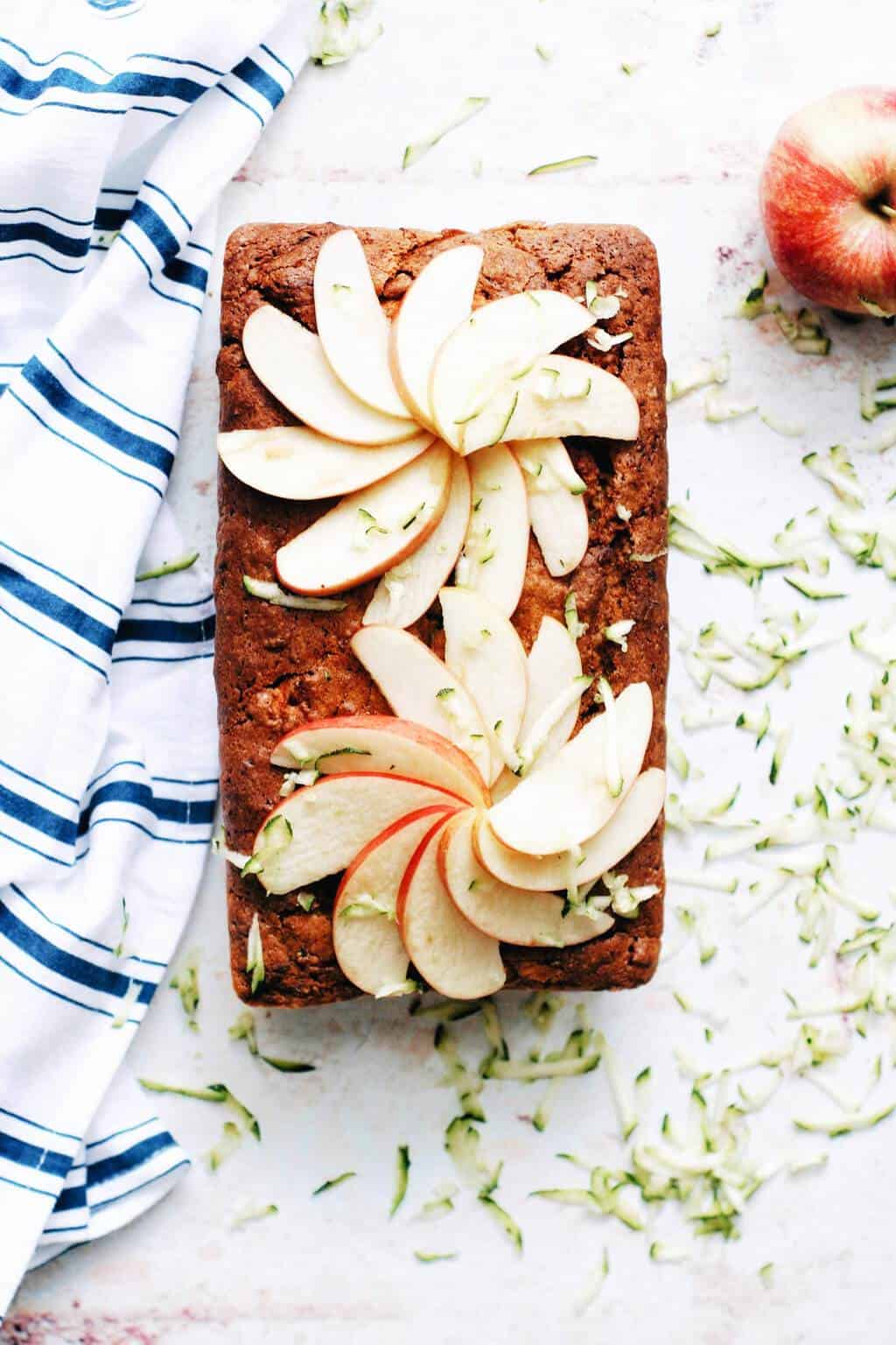 Overhead shot of zucchini apple bread loaf with apple slices on top