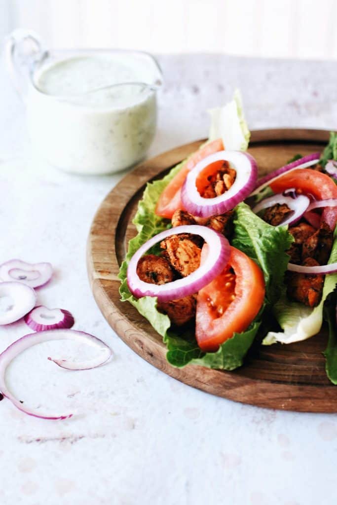 red onion and tomatoes topping lettuce wraps