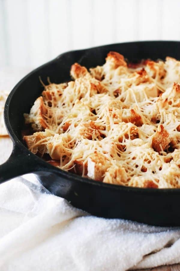 pan with toasted garlic bread and parmesan