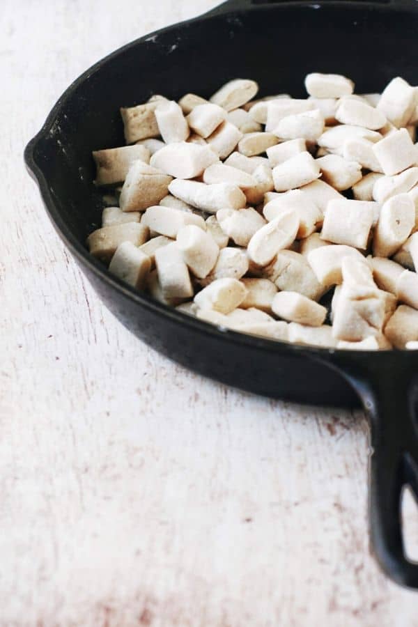 raw gnocchi in a cast iron skillet