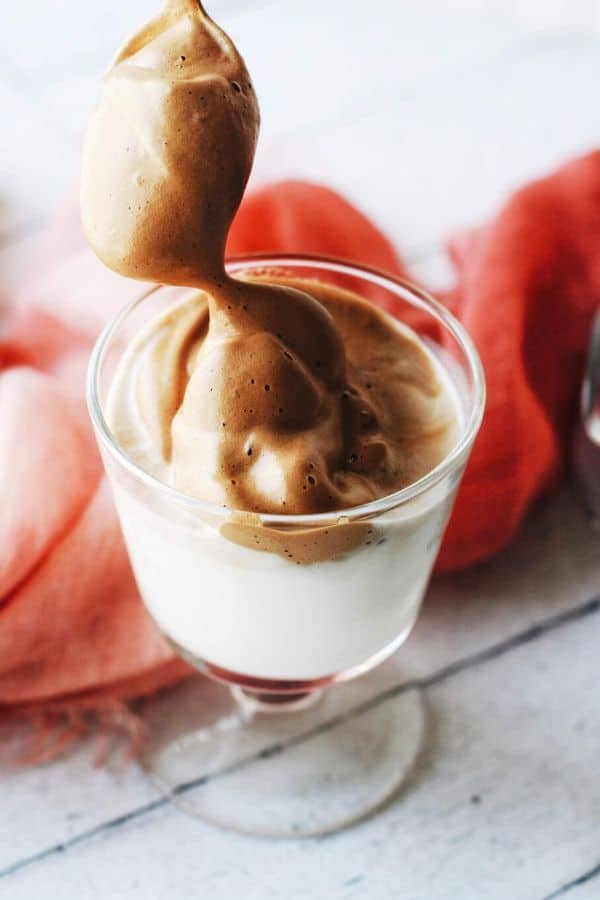 spoon dropping whipped coffee into milk