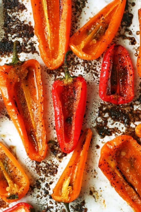 overhead shot of roasted mini peppers with spices