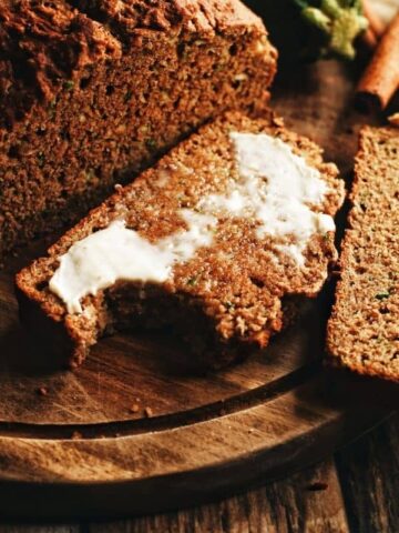 a slice of whole wheat zucchini bread with butter