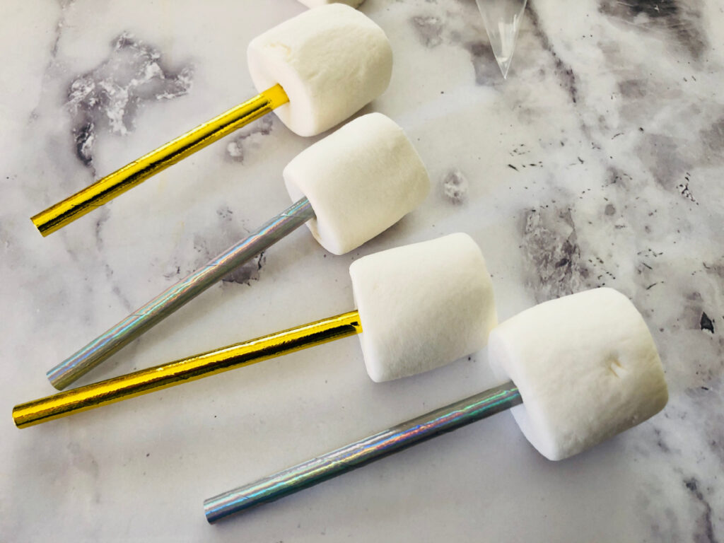 marshmallows on gold and silver sticks