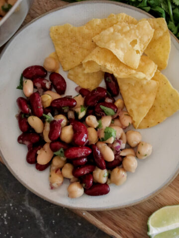 bean salad on a plate with chips