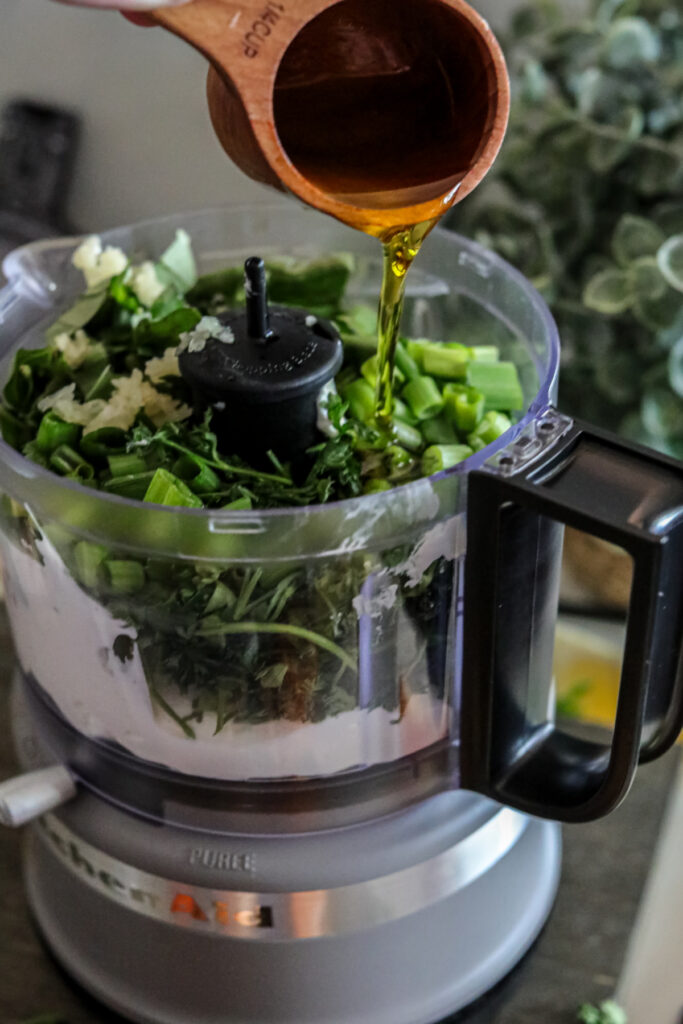 pouring oil into green goddess dressing
